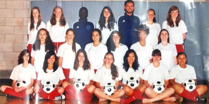 A photo of a girls' soccer team with their coaches