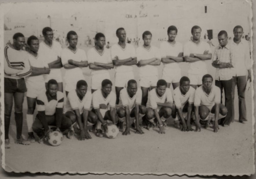 A black and white photo of a soccer team wearing white jerseys